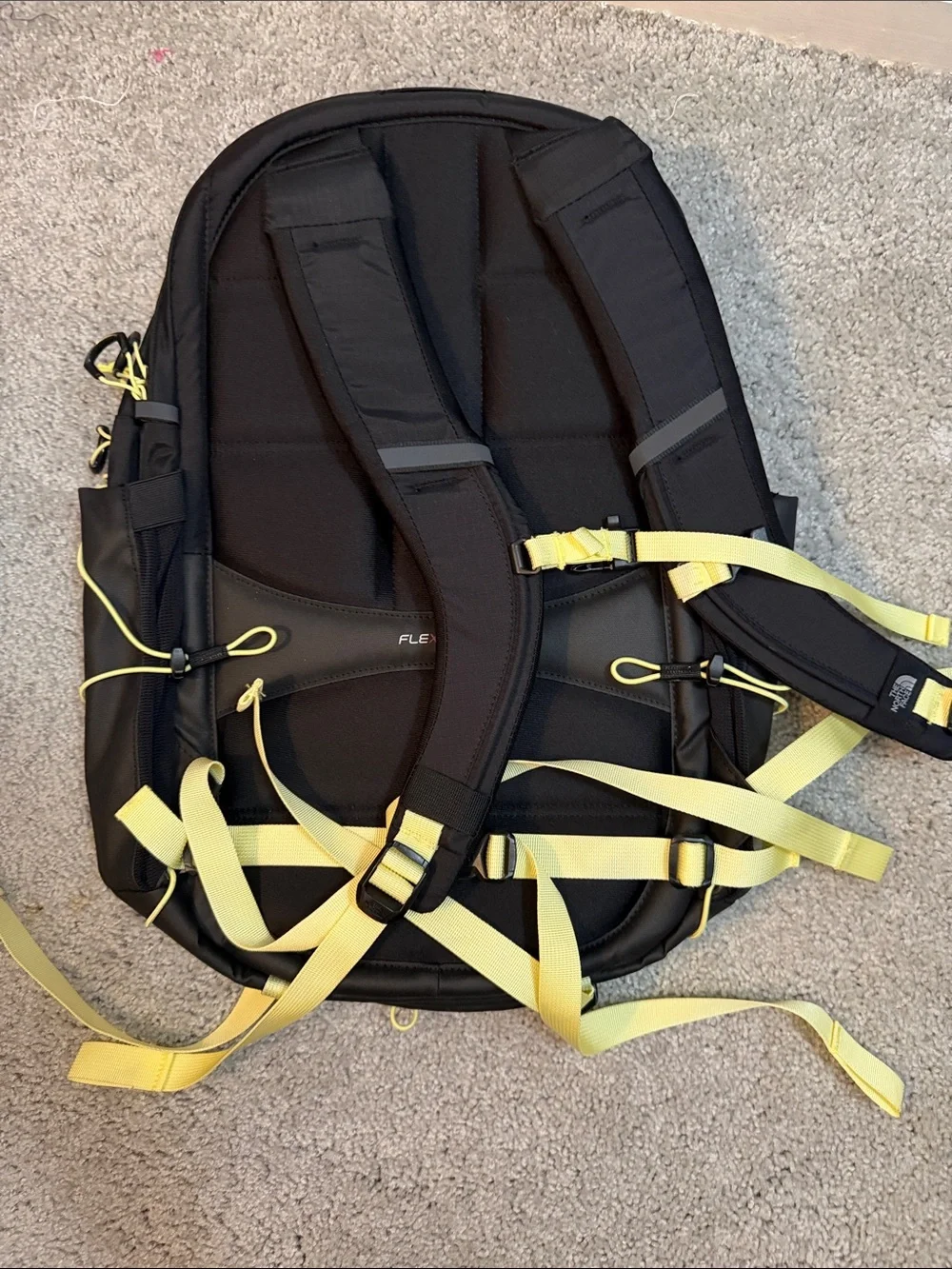 The North Face Black Backpack with Yellow Bungee and Straps